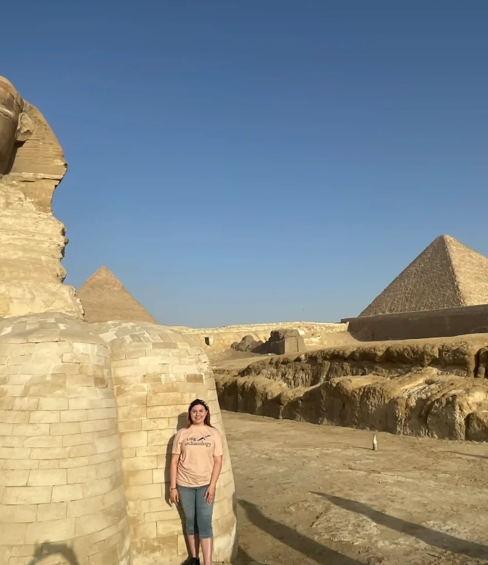 Eye on Egypt Travel guest infront of the paws of the sphinx as a part of the Private VIP Egypt tours